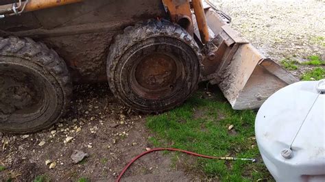 fix a flat in skid steer tire|skid loader tire repair without jack.